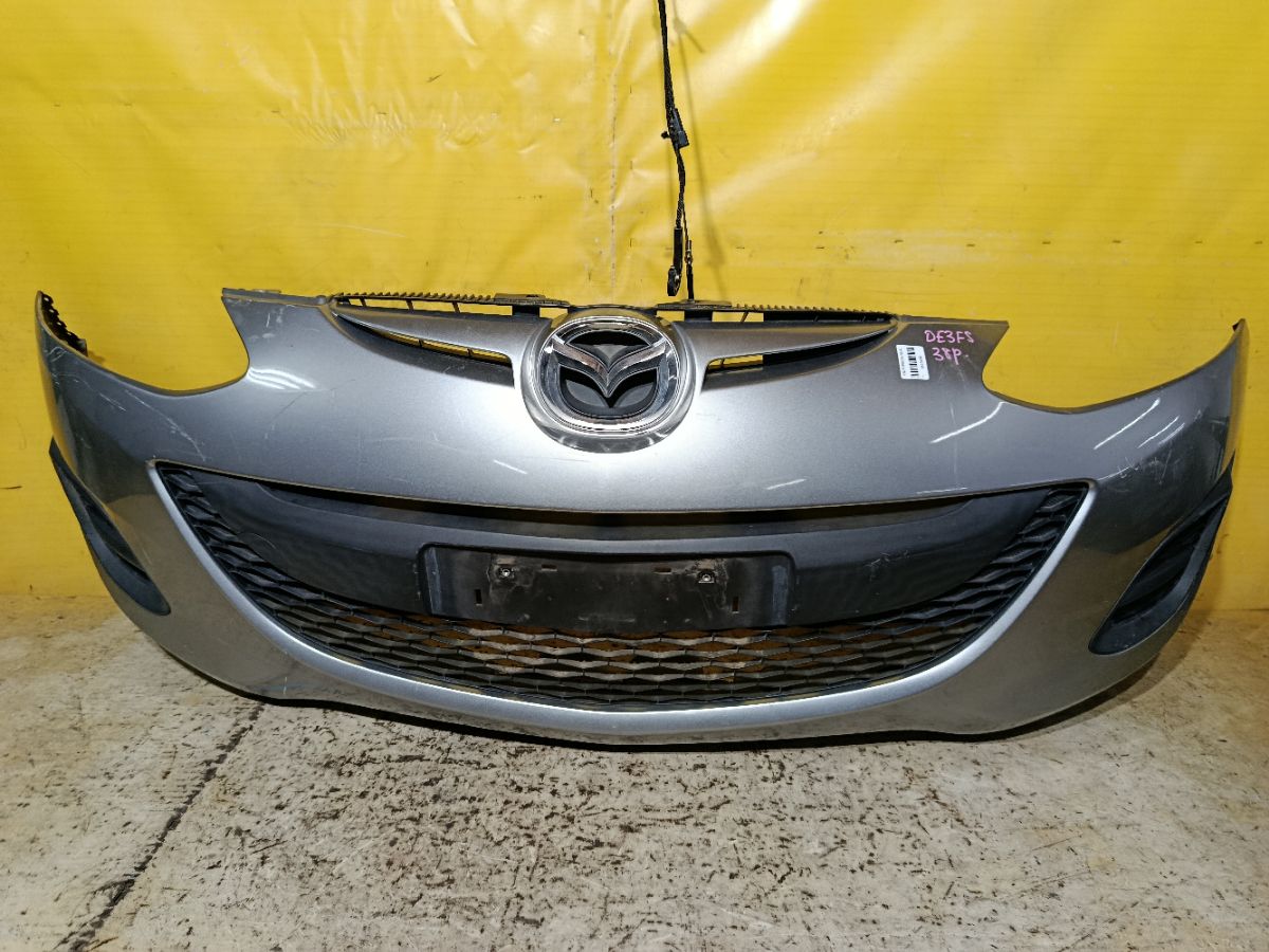 Бампер DR61-500312, 038D65150031C8N, 25301967, 2741570, 3421901, 5605050, 931104, D65150031B8H, D65150031BAA, D65150031C8N, D65150031CAA, D65150031CBB, MZ04105BA, MZ04105BAV, MZ04105BB, MZ51100000000, STMZ520000 на Mazda Demio DE3FS Фото 1